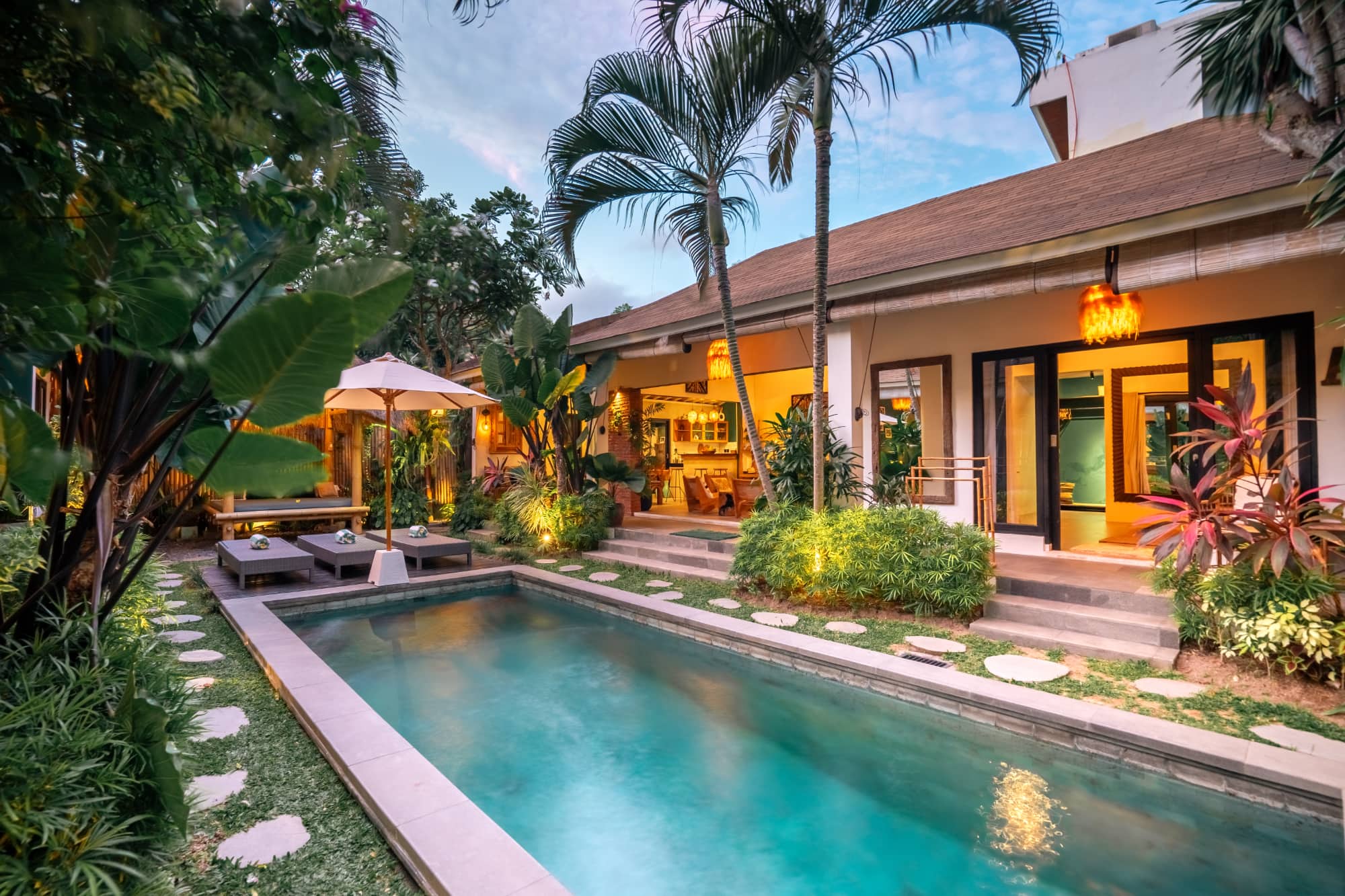 Villa Mint Satu: pool and garden lit up in the evening